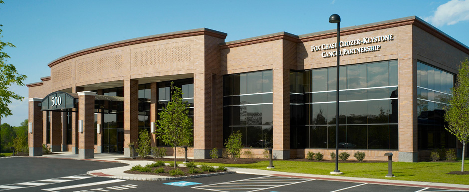 The exterior of Crozen Brinton, showcasing the stacked wall design made of glass a nd brick.
