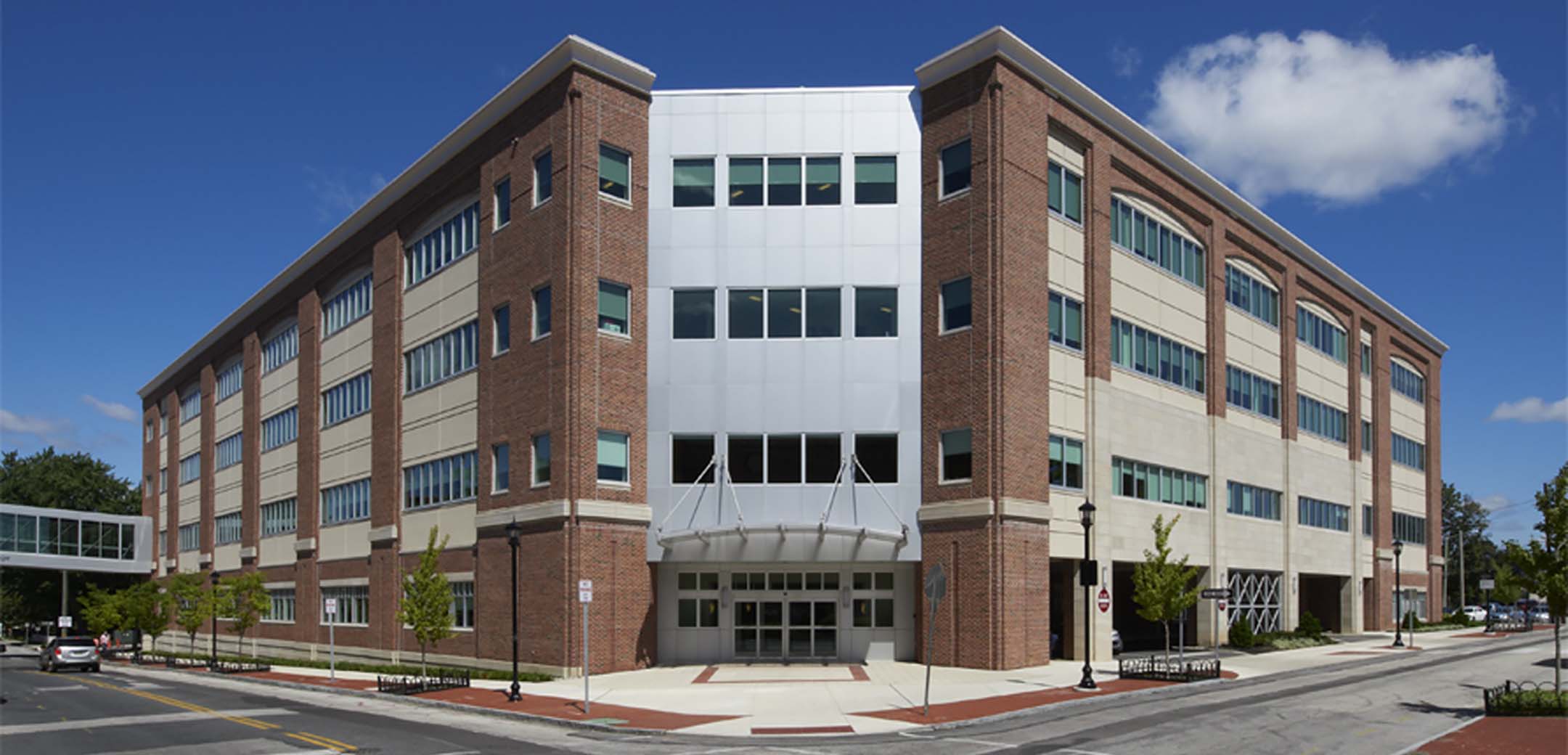 The exterior of the Bryn Mawr hospital showcasing the main corner entrance and the street it is on.