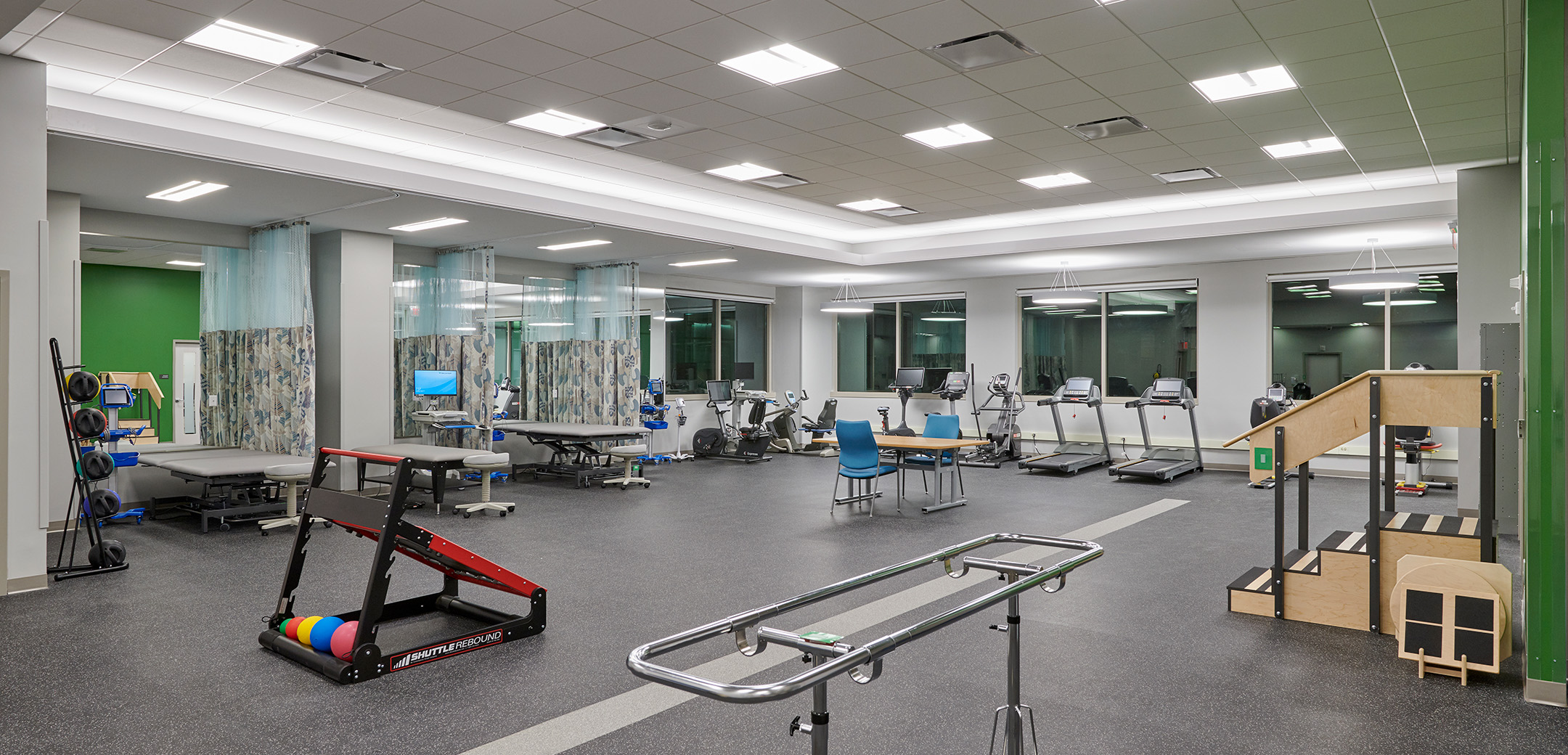 An angled interior view of the Main Line Women's Health Center showcasing the rehab facilities including stretching, cardio and assisting training equipment.