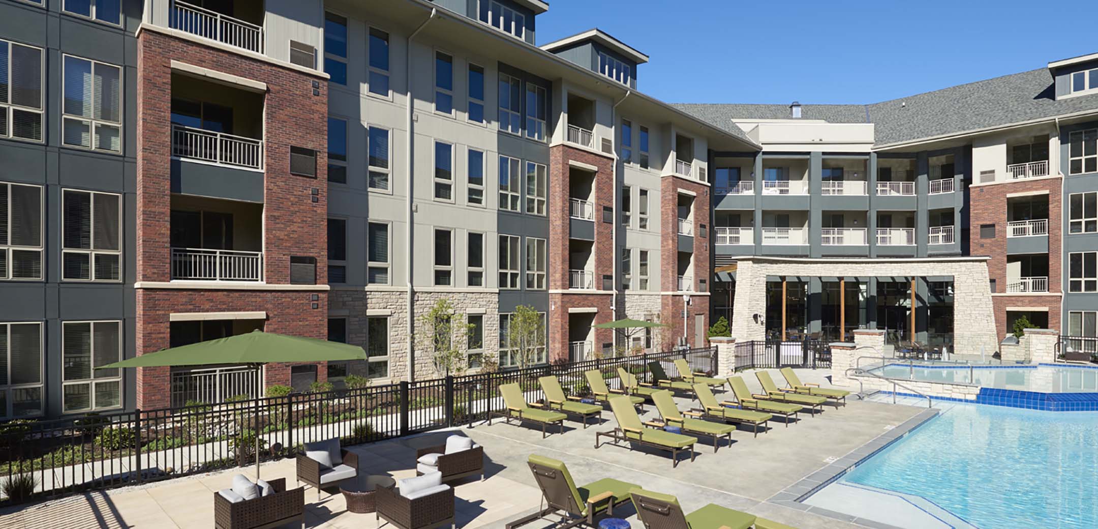 A close up view of the Maybrook buildings inner courtyard with an outside multi-level pool with seating around it.