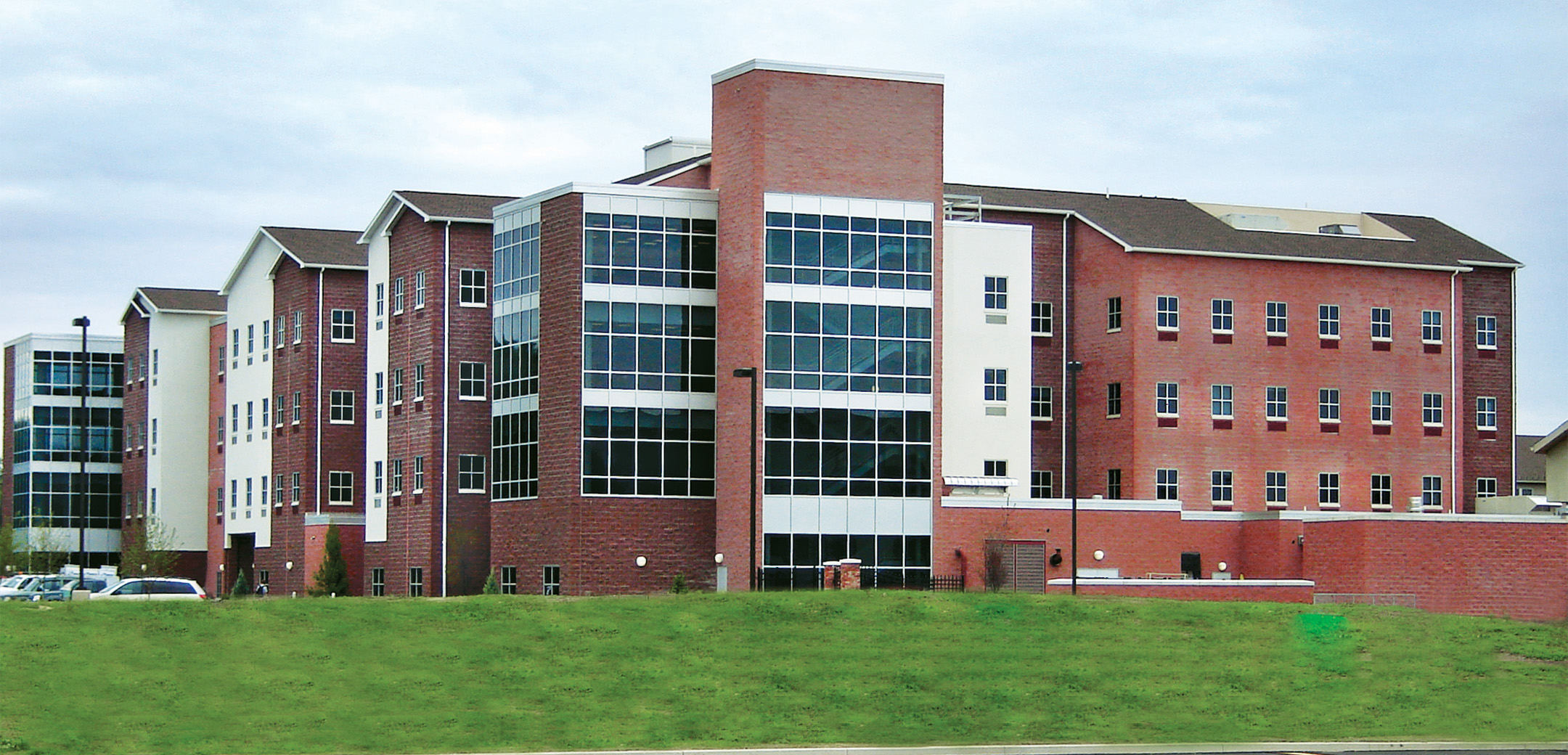 An angled view of the Stage x PA College building showcasing the glass floor to ceiling exterior wall and the front entrance.