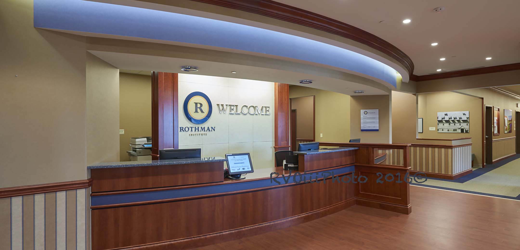 An interior view of the Rothman Brinton Lakes lobby, showcasing the reception desk and a hallway.