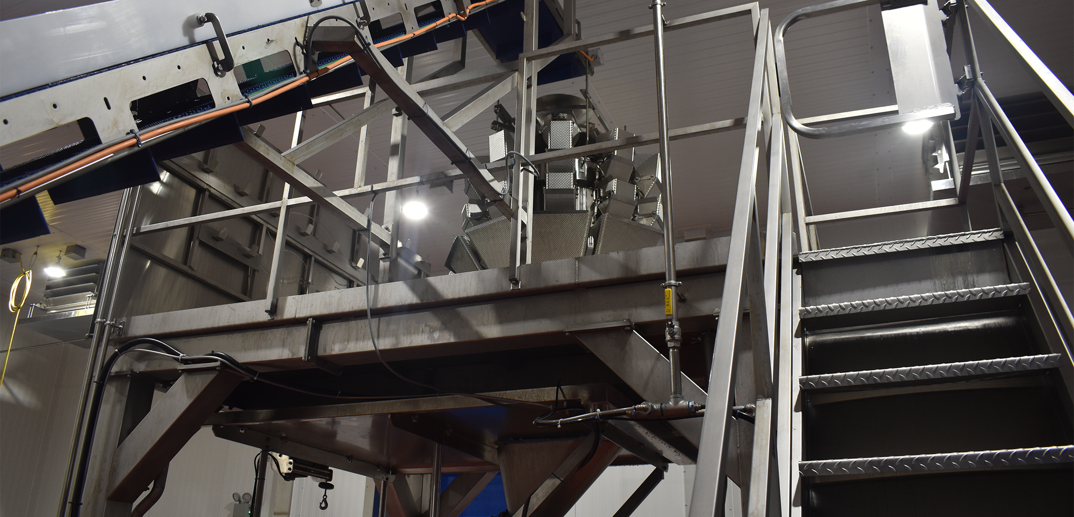 The interior of an industrial plant with a metal staircase.