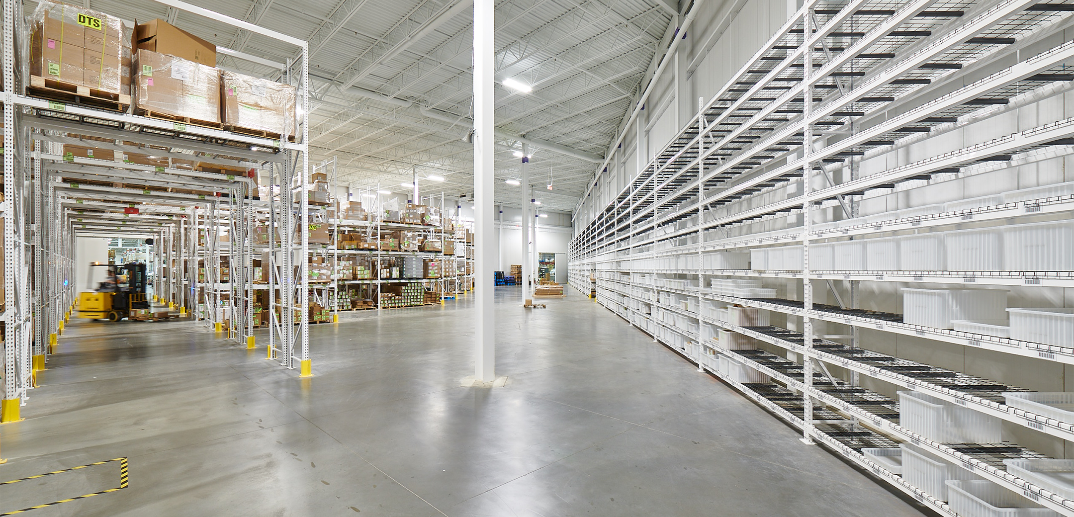 An interior view of the Streamlight warehouse, showcasing the tall industrial design, elevated shelves and side shelves.